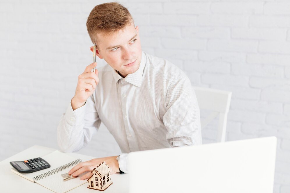thoughtful-handsome-realtor-office_23-2147737925